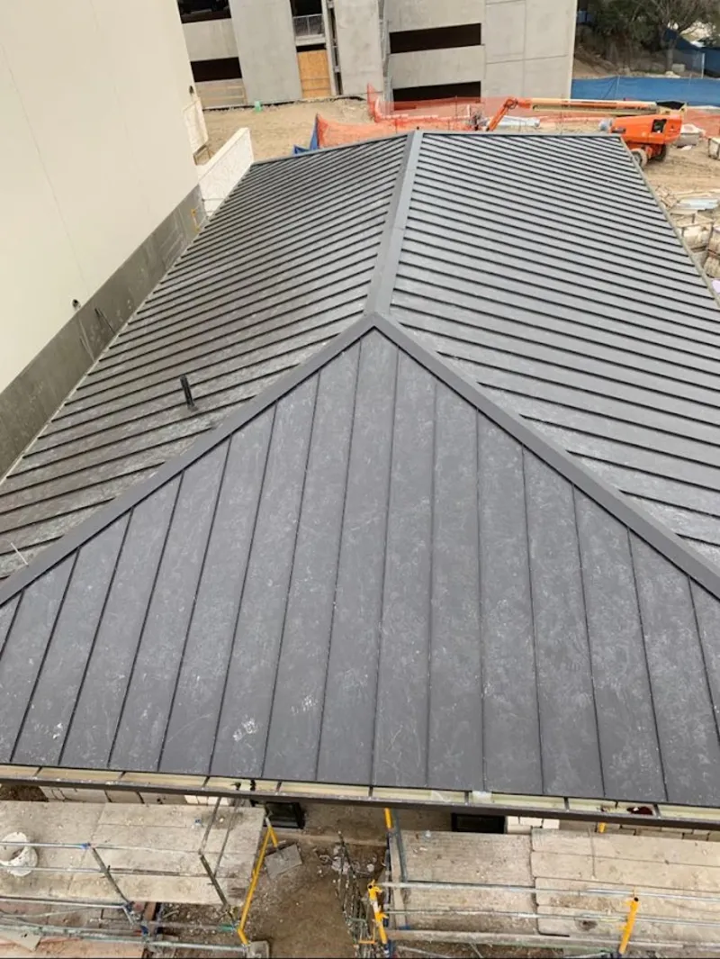 Commercial metal roof construction with crane equipment in Palestine